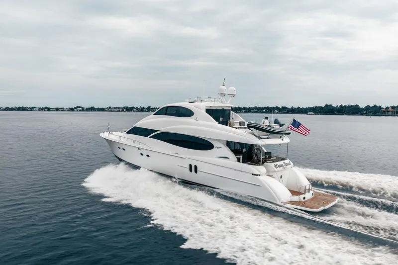 Water Ranch Yacht Photos Pics 2003 Lazzara 80 EB yacht cruising on open water with American flag.
