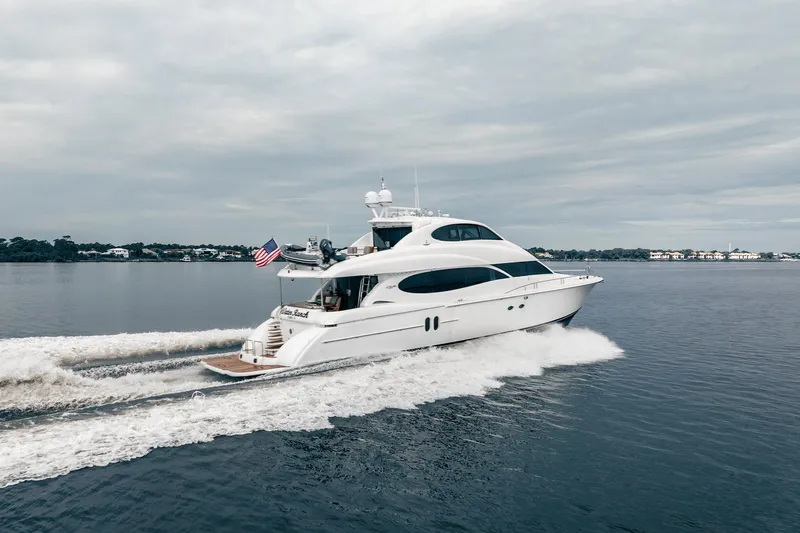 Water Ranch Yacht Photos Pics 2003 Lazzara 80 EB yacht cruising on calm waters under a cloudy sky.