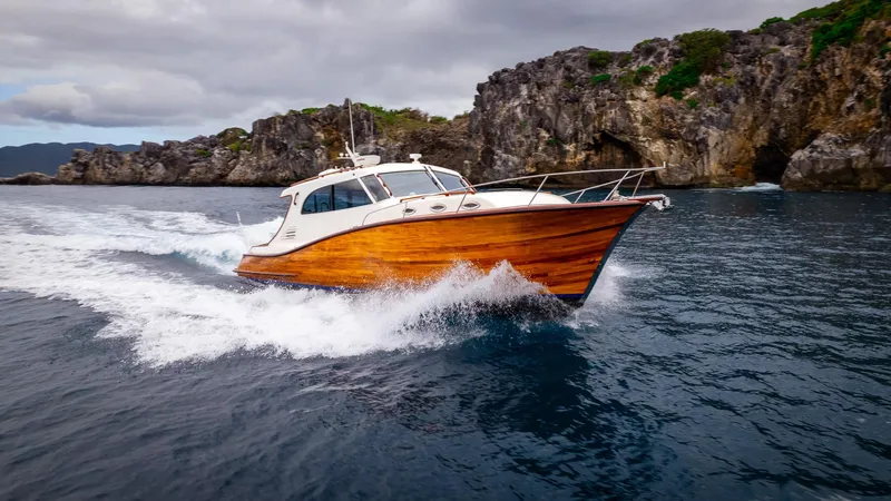 Trident Yacht Photos Pics Maverick Yachts Costa Rica 50, 2015 model, cruising near rocky coastline.