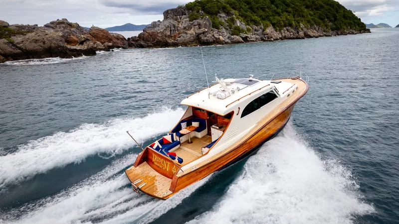 Trident Yacht Photos Pics Luxurious 2015 Maverick Yachts Costa Rica 50 cruising near rocky coastline.