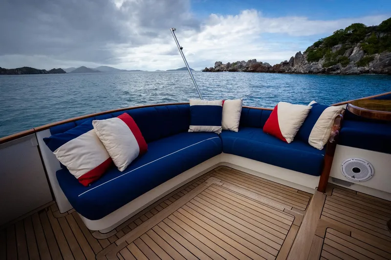 Trident Yacht Photos Pics Luxurious seating on 2015 Maverick Yachts Costa Rica 50, overlooking serene ocean and rocky coastline.