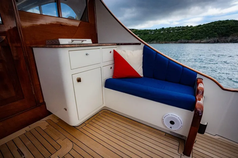 Trident Yacht Photos Pics Luxurious seating area on 2015 Maverick Yachts Costa Rica 50, featuring blue cushions and wooden accents.
