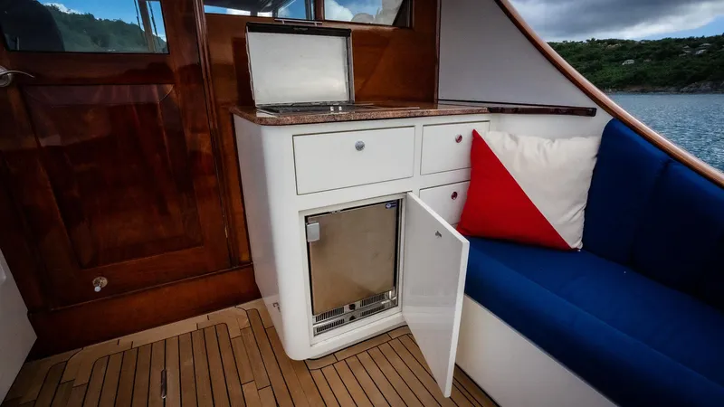 Trident Yacht Photos Pics Luxurious yacht interior with mini fridge, seating, and wooden accents on Maverick Yachts Costa Rica 50.