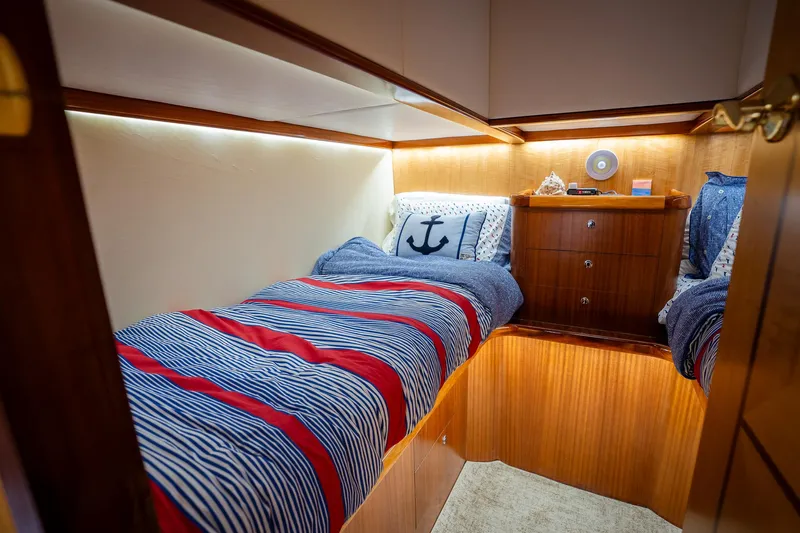 Trident Yacht Photos Pics Cozy cabin interior of 2015 Maverick Yachts Costa Rica 50 with nautical-themed bedding.