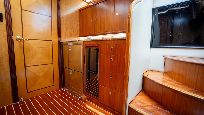 Trident Yacht Photos Pics Luxurious interior of 2015 Maverick Yachts Costa Rica 50, featuring wooden cabinetry and stairs.