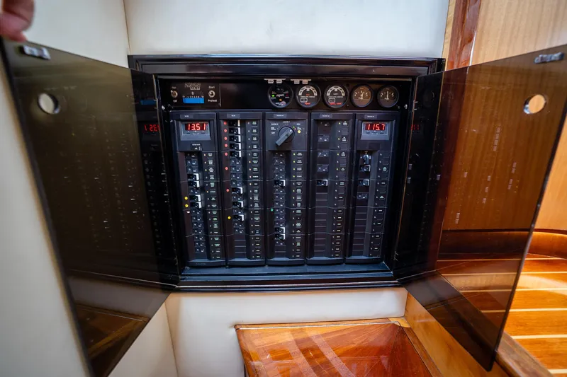 Trident Yacht Photos Pics Electrical panel inside 2015 Maverick Yachts Costa Rica 50, showcasing circuit breakers and gauges.