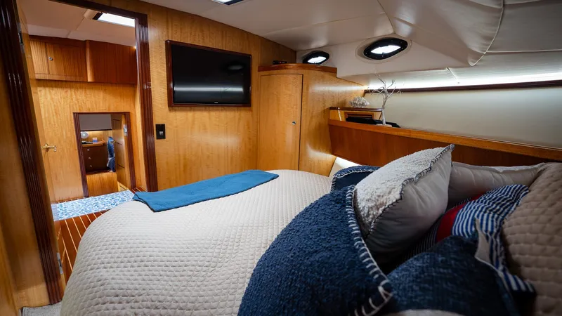 Trident Yacht Photos Pics Luxurious cabin interior of 2015 Maverick Yachts Costa Rica 50, featuring cozy bedding and wood finishes.