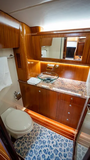Trident Yacht Photos Pics Luxurious bathroom in 2015 Maverick Yachts Costa Rica 50, featuring elegant wood and marble finishes.