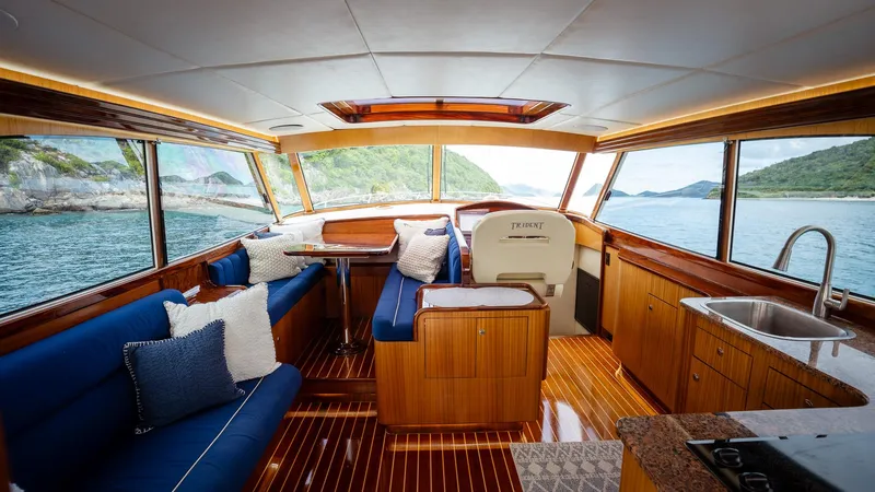 Trident Yacht Photos Pics Luxurious interior of 2015 Maverick Yachts Costa Rica 50, featuring elegant wood finishes and scenic views.