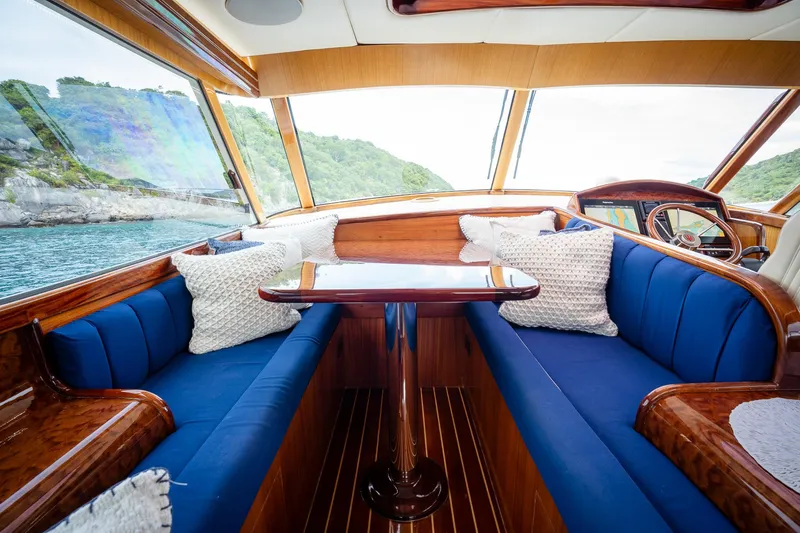 Trident Yacht Photos Pics Luxurious interior of 2015 Maverick Yachts Costa Rica 50 with blue seating and scenic view.