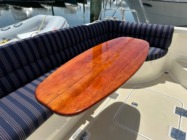 Encore Yacht Photos Pics 2017 Sabre 42 Salon Express yacht with striped seating and polished wooden table.