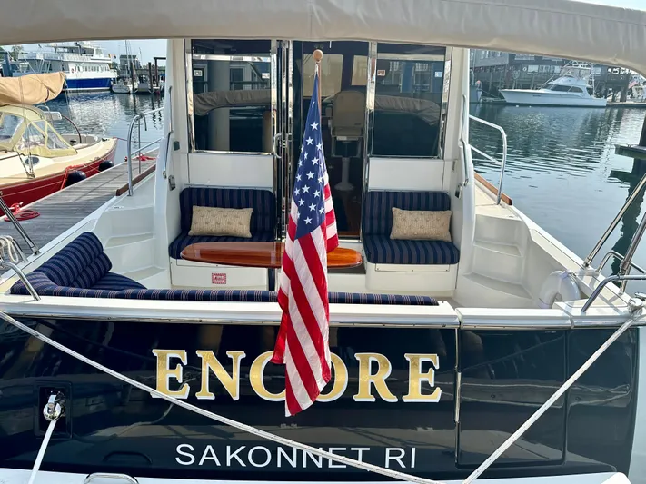 Encore Yacht Photos Pics 2017 Sabre 42 Salon Express yacht "Encore" docked in Sakonnet, RI, with American flag.