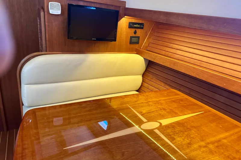 Encore Yacht Photos Pics Interior of 2017 Sabre 42 Salon Express with wooden table and cushioned seating.