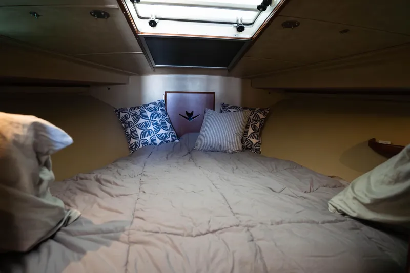 Barefoot Girl Yacht Photos Pics Cozy cabin interior of 1984 Bertram 35 Convertible with pillows and skylight.