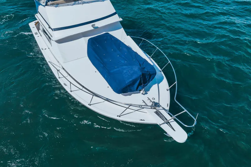 Barefoot Girl Yacht Photos Pics 1984 Bertram 35 Convertible boat on blue ocean water, aerial view.