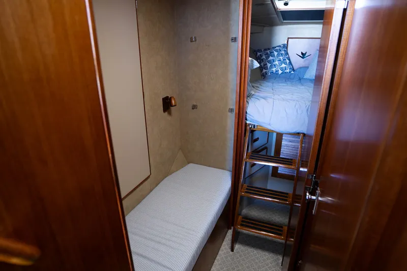 Barefoot Girl Yacht Photos Pics 1984 Bertram 35 Convertible cabin interior with bunk beds and wooden ladder.