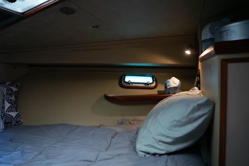 Barefoot Girl Yacht Photos Pics Cozy cabin interior of 1984 Bertram 35 Convertible with bed and porthole.