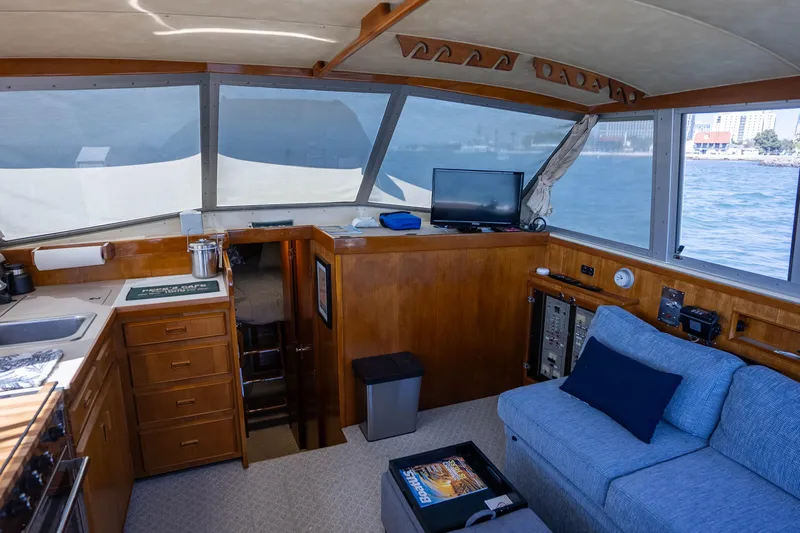 Barefoot Girl Yacht Photos Pics Interior of a 1984 Bertram 35 Convertible yacht with cozy seating and ocean view.