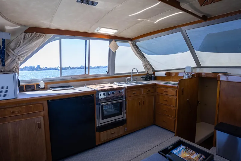 Barefoot Girl Yacht Photos Pics Interior of 1984 Bertram 35 Convertible yacht with kitchen and ocean view.