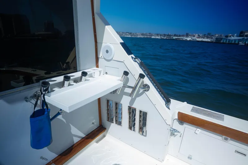 Barefoot Girl Yacht Photos Pics 1984 Bertram 35 Convertible boat deck with fishing rod holders, ocean view.