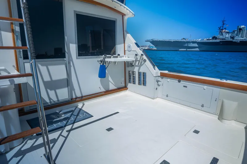 Barefoot Girl Yacht Photos Pics 1984 Bertram 35 Convertible yacht deck with ocean view and distant ship.