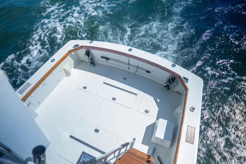 Barefoot Girl Yacht Photos Pics 1984 Bertram 35 Convertible boat deck with ocean view, featuring spacious layout and wooden accents.