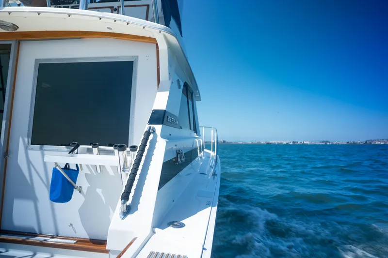 Barefoot Girl Yacht Photos Pics 1984 Bertram 35 Convertible yacht cruising on open blue water under clear skies.