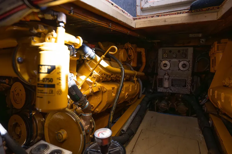 Barefoot Girl Yacht Photos Pics Engine room of a 1984 Bertram 35 Convertible boat with visible machinery.