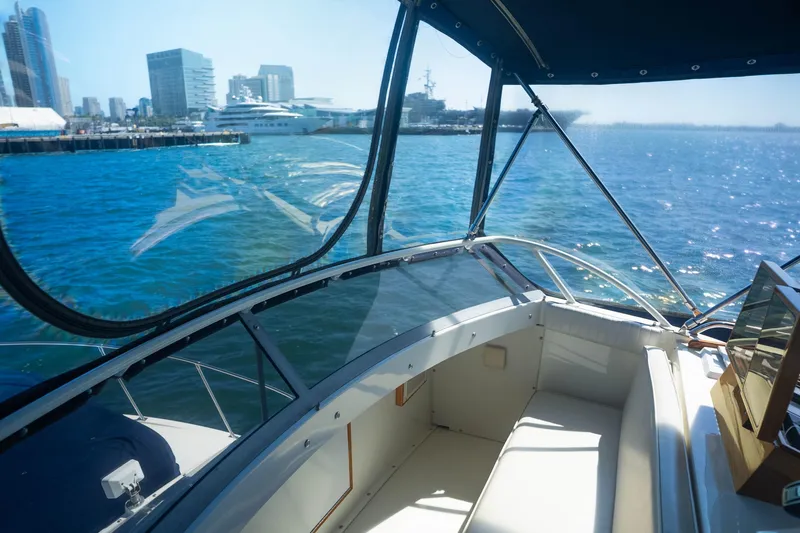 Barefoot Girl Yacht Photos Pics Interior view of 1984 Bertram 35 Convertible yacht with city skyline in background.