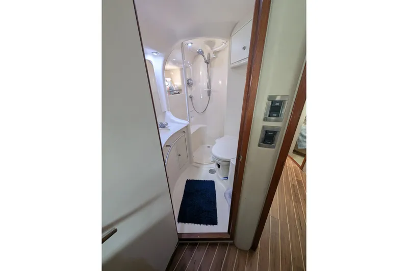  Yacht Photos Pics 1998 Sea Ray 480 Sedan Bridge bathroom with shower, toilet, and wooden flooring.
