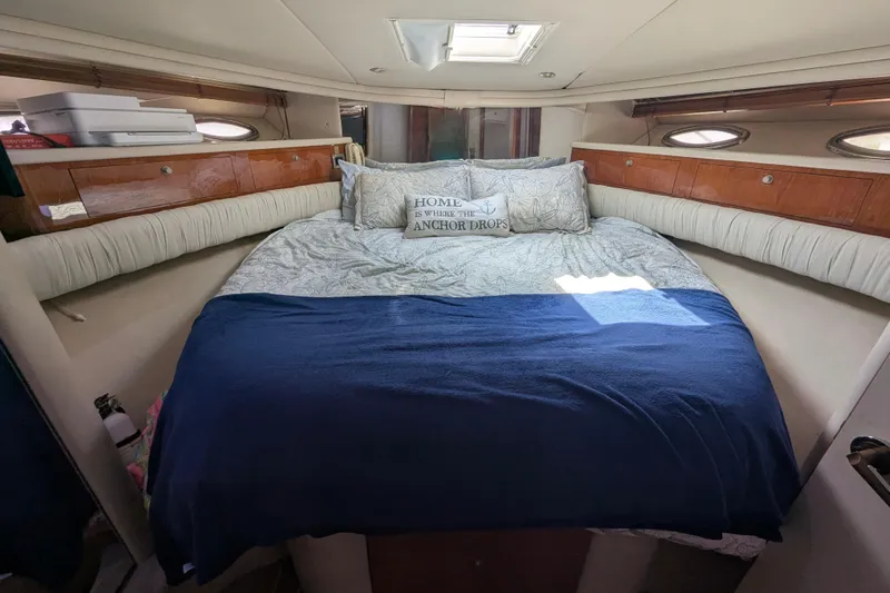  Yacht Photos Pics Cozy bedroom interior of 1998 Sea Ray 480 Sedan Bridge yacht with nautical decor.