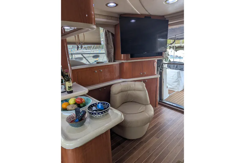  Yacht Photos Pics Luxurious interior of 1998 Sea Ray 480 Sedan Bridge with leather chair and flat-screen TV.