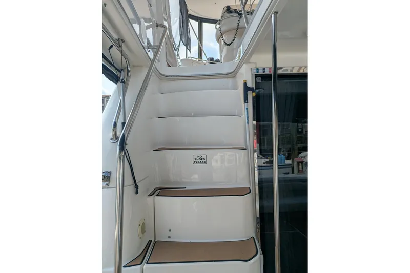  Yacht Photos Pics Staircase on 1998 Sea Ray 480 Sedan Bridge yacht with "No Shoes" sign.