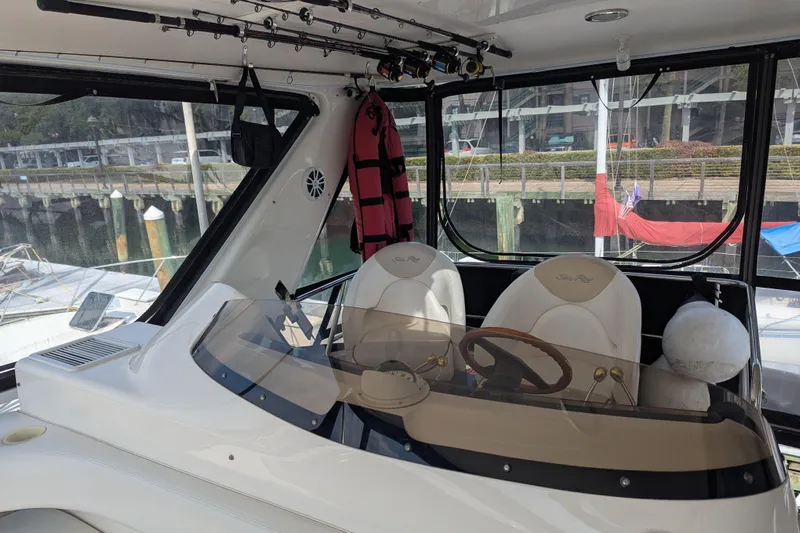  Yacht Photos Pics Interior view of 1998 Sea Ray 480 Sedan Bridge yacht with helm and fishing rods.