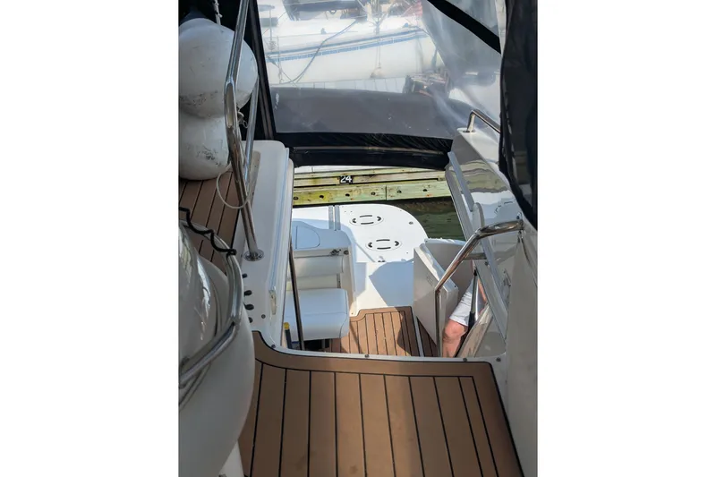  Yacht Photos Pics 1998 Sea Ray 480 Sedan Bridge yacht interior with teak flooring and seating area.
