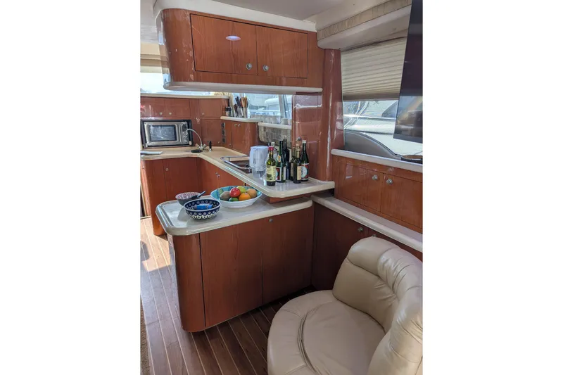  Yacht Photos Pics Luxurious 1998 Sea Ray 480 Sedan Bridge yacht interior with modern kitchen and seating.