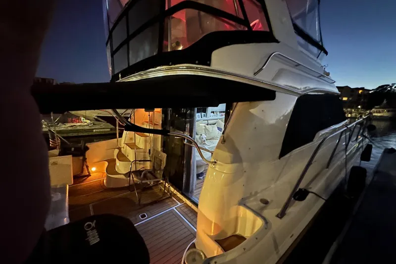  Yacht Photos Pics 1998 Sea Ray 480 Sedan Bridge yacht docked at night, illuminated interior.