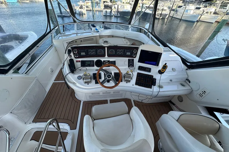  Yacht Photos Pics 1998 Sea Ray 480 Sedan Bridge helm with modern controls and panoramic marina view.