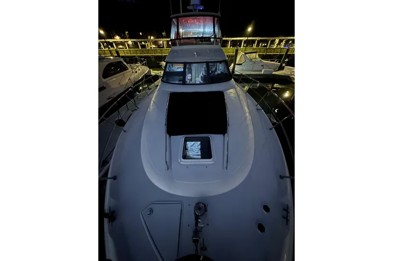  Yacht Photos Pics 1998 Sea Ray 480 Sedan Bridge yacht docked at night, showcasing sleek design and spacious deck.