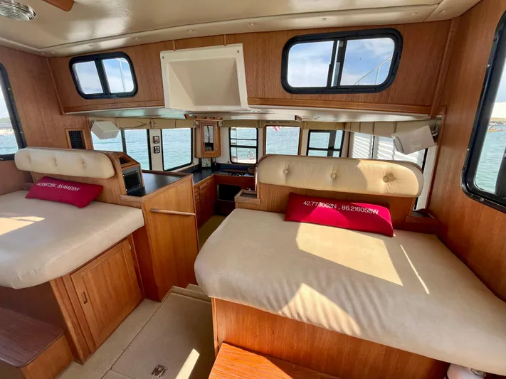Nomad Yacht Photos Pics Interior of 2000 Nordic Tug 37 with cozy seating and nautical decor.