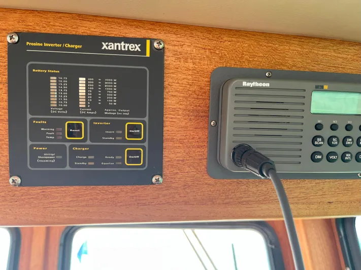 Nomad Yacht Photos Pics Control panel on a 2000 Nordic Tug 37, featuring Xantrex inverter and Raytheon radio.