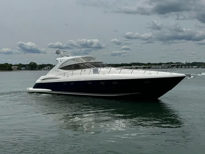  Yacht Photos Pics 2003 Cruisers Yachts 540 Express on calm water under cloudy sky.