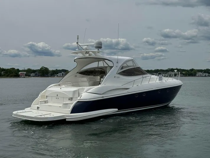  Yacht Photos Pics 2003 Cruisers Yachts 540 Express on calm water, showcasing sleek design and luxury features.