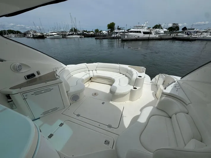  Yacht Photos Pics 2003 Cruisers Yachts 540 Express with spacious white seating area, docked at marina.