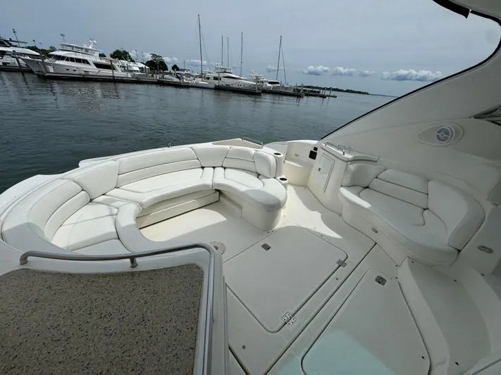  Yacht Photos Pics 2003 Cruisers Yachts 540 Express with spacious white seating area, docked at marina.