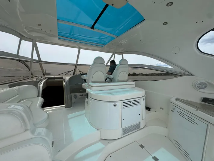  Yacht Photos Pics Interior of 2003 Cruisers Yachts 540 Express with white seating and blue skylight.