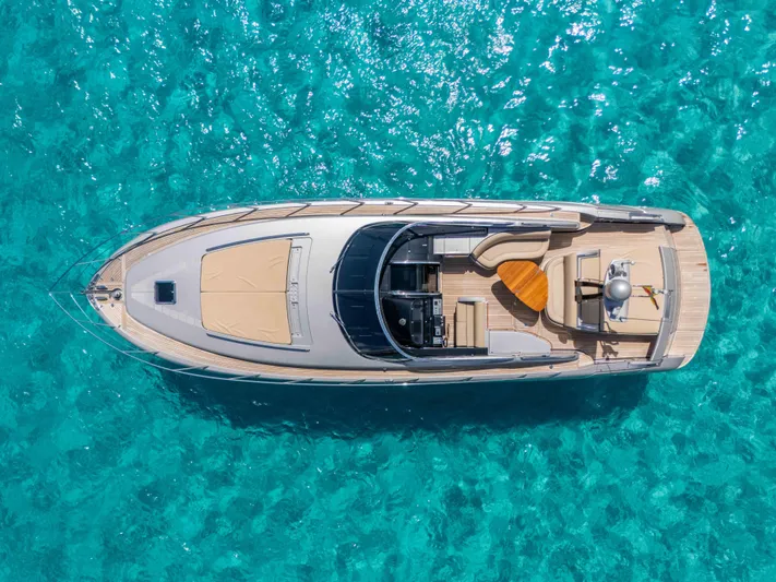 Vimojal II Yacht Photos Pics Aerial view of 2009 Riva 52' le yacht on clear turquoise water.