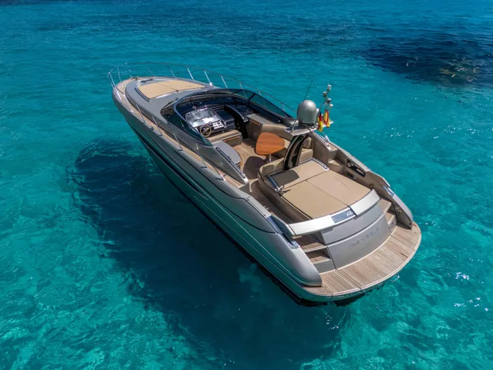 Vimojal II Yacht Photos Pics Luxurious 2009 Riva 52' le yacht cruising on clear turquoise waters.