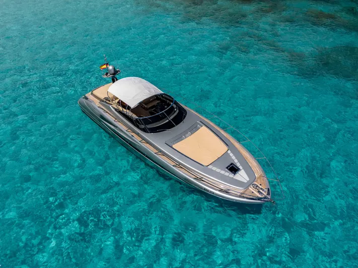 Vimojal II Yacht Photos Pics Luxurious 2009 Riva 52' le yacht on clear turquoise water.