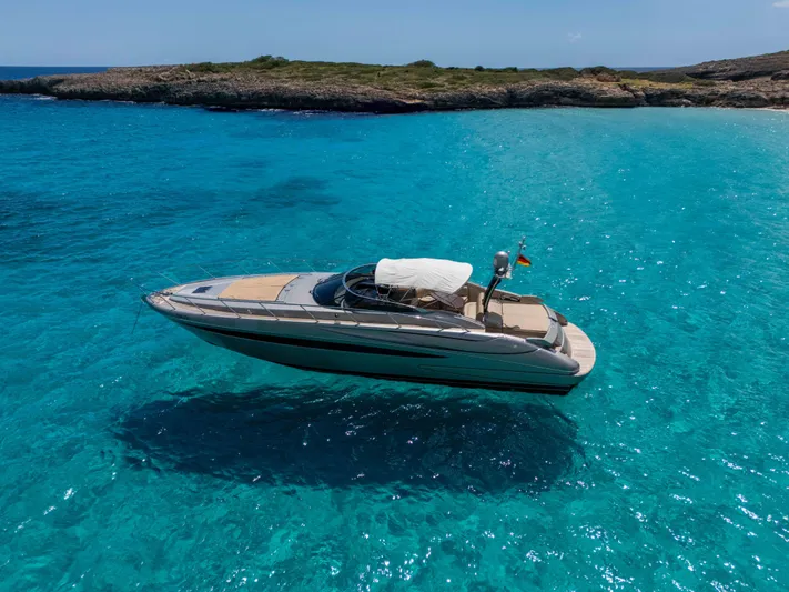 Vimojal II Yacht Photos Pics Luxurious 2009 Riva 52' le yacht cruising in clear turquoise waters.